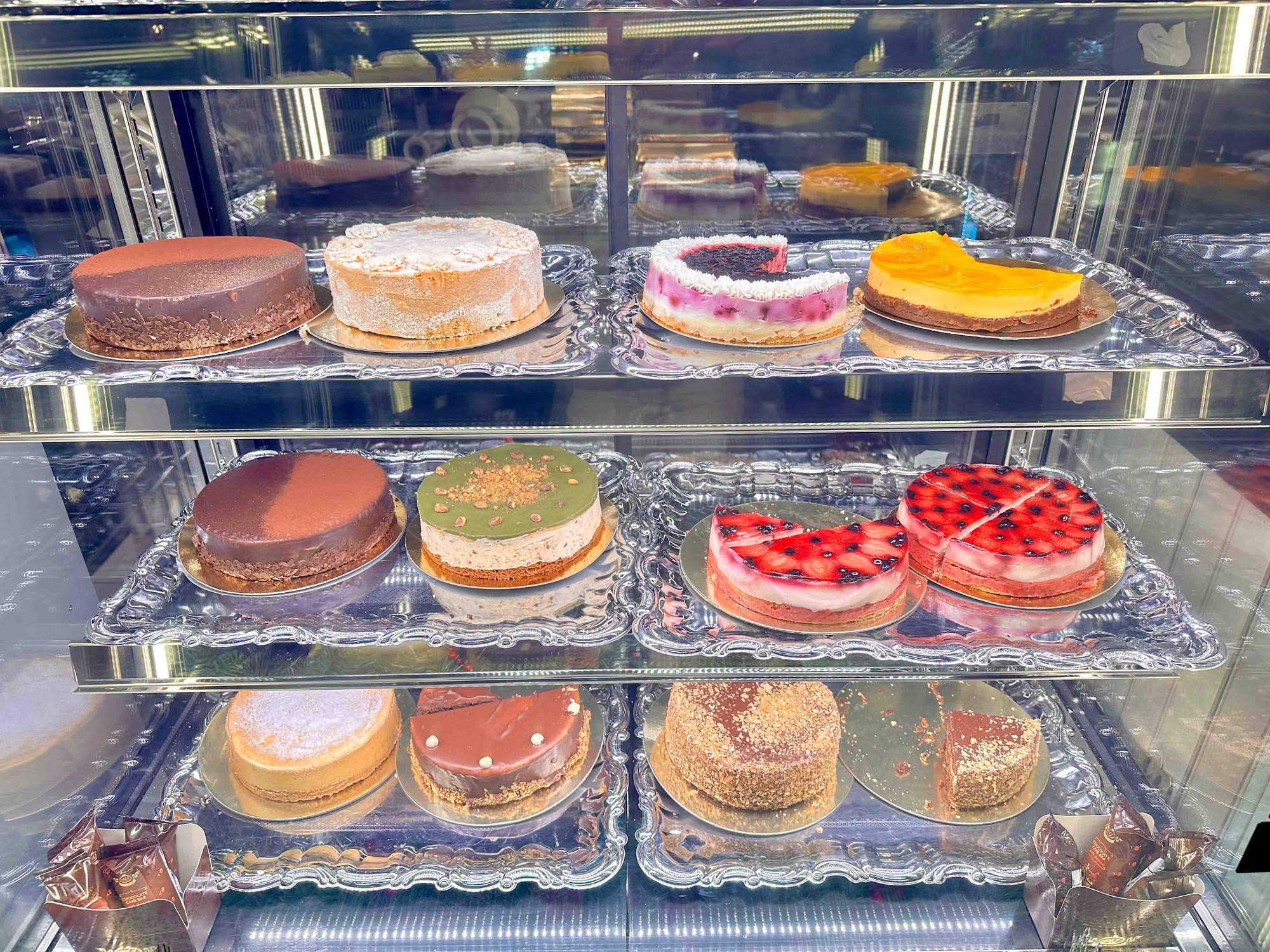 glass case with various cakes